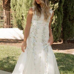 White midi dress with floral embroidery.